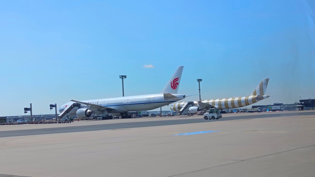 Passenger aircraft parked beside terminal buildings at Frankfurt Airport